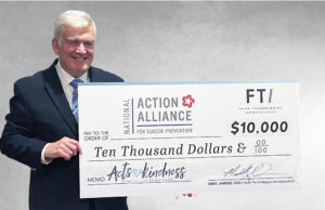 Robert F. McCauley from Nation Action Alliance for Suicide Prevention accepting the $10,000 check from FTI.