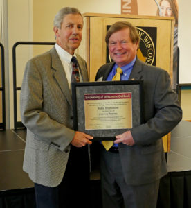 Rollie Stephenson receiving the "Distinguished Honorary Alumnus of the Year Award" from the University of Wisconsin Oshkosh College of Business Dean, William Tallon, on October 17, 2014.
